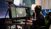 Woman Streamer Checking Sound Using Professional Mixer For Streaming Video Games In Gaming Home Studio. Pro Gamer Playing First Person Shooter Video Games Talking With Team Mates On Open Chat