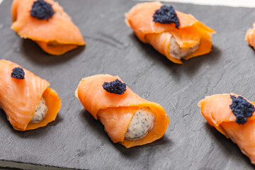 Wall Mural - smoked salmon rolls filled with cream cheese and black caviar