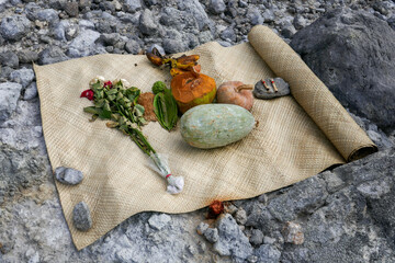 Offerings of flowers, fruit and cigarettes on a bamboo mat, an ancient traditional belief, in the crater of Gunung Sibayak volcano near Berastagi, North Sumatra, Indonesia