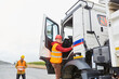 © Robert Kneschke - Truck driver climbs into his truck with a delivery