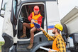 © Robert Kneschke - Truck driver brings delivery to construction site with worker