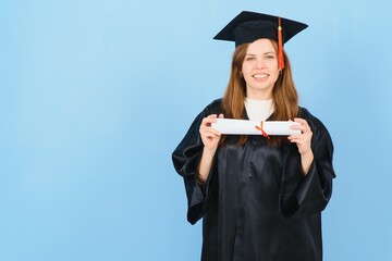 Woman graduate student wearing graduation hat and gown, on blue background