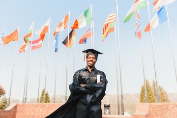 happy african american male college graduate at ceremony