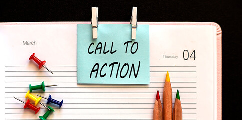 text Call To Action on stickers on the diary with office tools