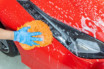 Team washing a Ferrarri 488 in an artisanal way in Andorra in 2021