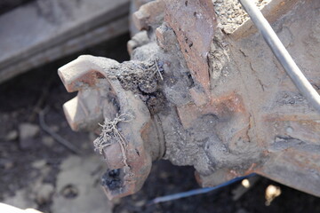 Wall Mural - Old heavy truck cardan dirty cross joint mounting and reducer box on lorry rear axle close up, vehicle transmission repair service