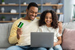 © Prostock-studio - Cheerful african american father and daughter shopping online