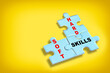 Soft skills and hard and skills written on blue puzzle jigsaw with shadow on yellow background. Behavior and thinking concept