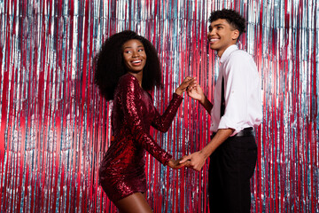 Poster - Profile side photo of young black couple happy smile dance new year party suspenders red sequins dress isolated over glitter color background