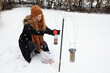 © Johnér - Woman filling bird feeders in winter