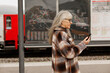 © Johnér - Mature woman at train station