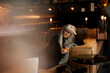 © Johnér - Mature woman in cafe using cell phone