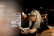 © Johnér - Mature woman in cafe reading book