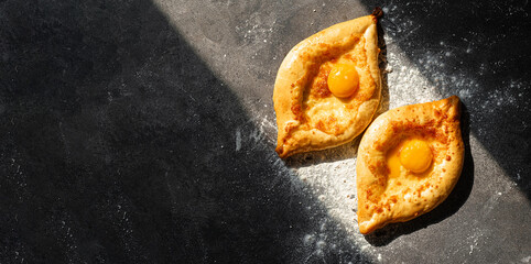 two Adjarian khachapuri in traditional classic Georgian style.