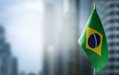Wall Mural - A small flag of Brazil on the background of a blurred background