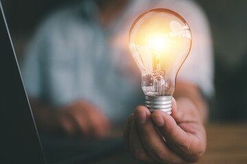 Poster - idea and light bulbs concept, businessman show new ideas with innovative technology and creativity.