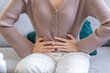 Flatulence young asian woman, girl hand in stomach ache, suffer from food poisoning, abdominal pain and colon problem, gastritis or diarrhoea. Patient belly, abdomen or inflammation, concept.
