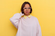 © Asier - Young student mixed race woman isolated on yellow background touching back of head, thinking and making a choice.