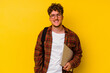 © Asier - Young student caucasian man holding a laptop isolated on yellow background happy, smiling and cheerful.