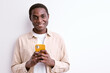 nice young afro man holding mobile phone in hands creating social strategy influencer thinking