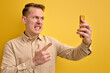 Side view Portrait Of Irritated Man Scolding Someone Via Smartphone