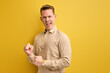 happy attractive cheerful cheery glad content guy showing winning gesture isolated on yellow