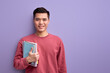 Smiling Asian guy with book in hands enjoy education and university, posing