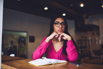 Wall Mural - Pensive black woman with book in cafe