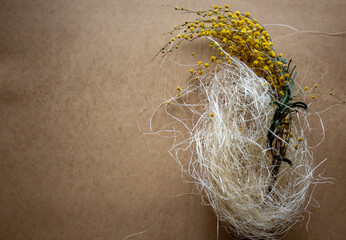 Yellow flowers on a brown paper background.