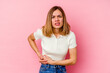© Asier - Young caucasian woman isolated on pink background having a liver pain, stomach ache.