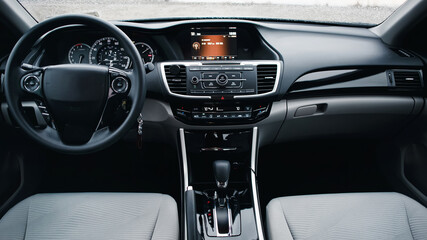 Wall Mural - Modern car Interior. Steering wheel, shift lever and dashboard. Detail of modern car interior. Automatic gear stick.