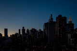 Fototapeta Nowy Jork - New york city building night sky with lights and setting sun