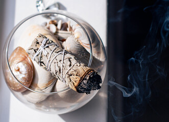 Burning sage in a home on a dark background