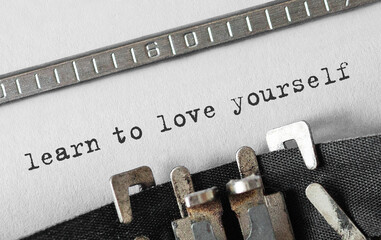 Poster - text learn to love yourself typed on retro typewriter