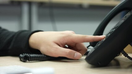 Wall Mural - close up employee man hand press number on telephone for contact with someone , technology concept