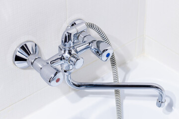 close up view for bathroom faucet over tile background. domestic bath supply. plumbing concept