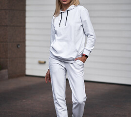 Poster - for Girl wears white hoodie and pants. Blonde woman in loose tracksuit with no logo