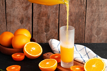 Orange juice pouring from the bottle into the glass