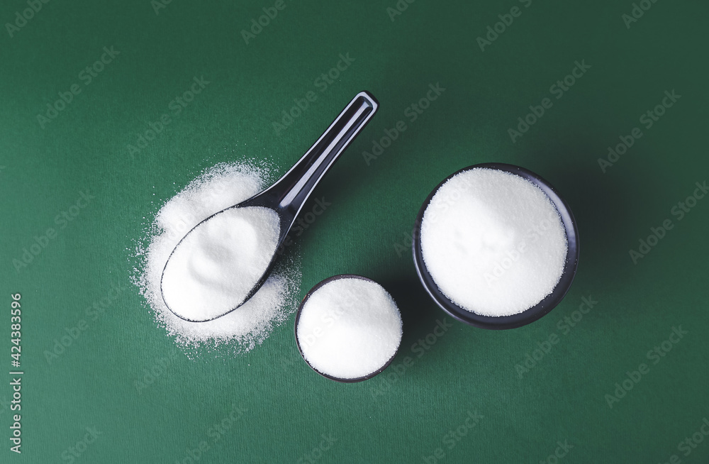 Bowls of salt on color background