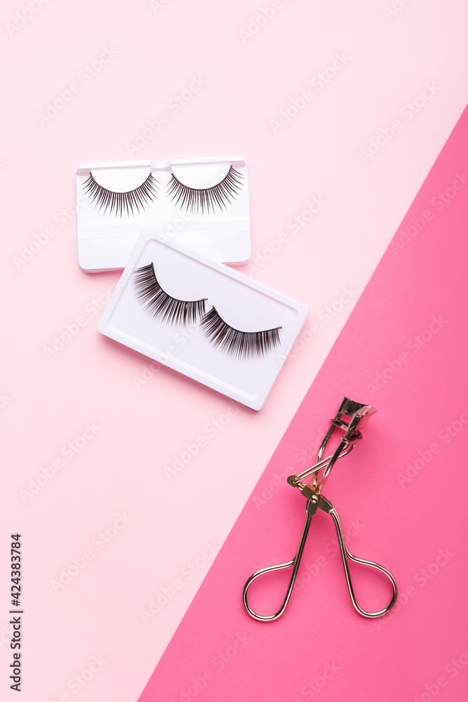 Composition with false eyelashes on color background