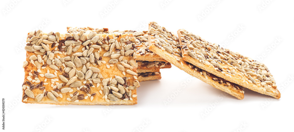 Tasty crackers with seeds on white background