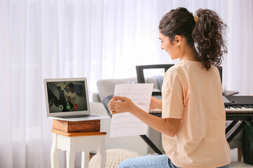 Sticker - Young woman giving music lessons online at home