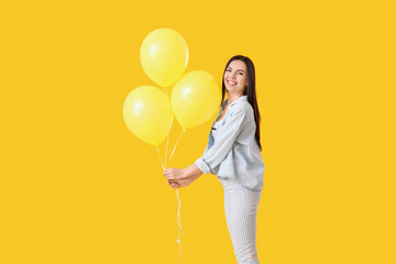 Poster - Beautiful young woman with balloons on color background