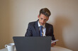 © Andrea - businessman in suit working at computer.
