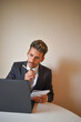 © Andrea - businessman in suit working at computer.