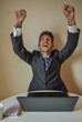 © Andrea - businessman in suit working at computer.
