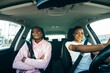 © F8  \ Suport Ukraine - Close up of african young women drive car. Little holiday trip of friends