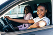 © F8  \ Suport Ukraine - Two african female friends on road trip driving in the car