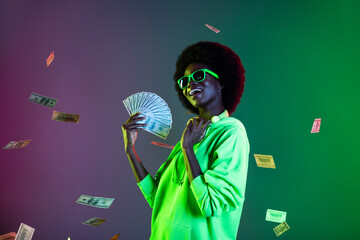 Wall Mural - Photo of rich luxury lady hold fan cash dollars fall wear specs sweatshirt isolated gradient green neon background