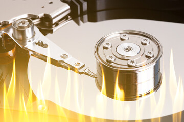 Poster - a hard disk with flame tongues. burnt disk in the computer. data loss